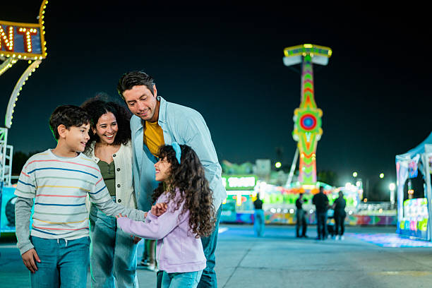 istock Family talking at amusement park 2210265522