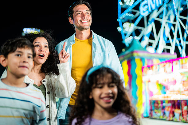 istock Family talking at amusement park 2210265528