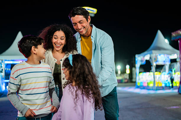 istock Family talking at amusement park 2210265530