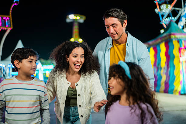 istock Family talking at amusement park 2210265531