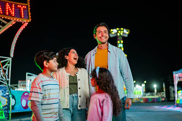 istock Family talking at amusement park 2210266032
