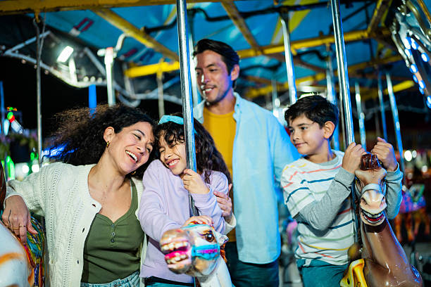 istock Family talking on carousel at amusement park 2210266051