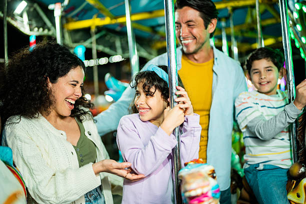 istock Family talking on carousel at amusement park 2210266079