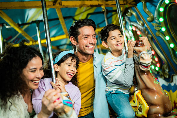 istock Family talking on carousel at amusement park 2210266088