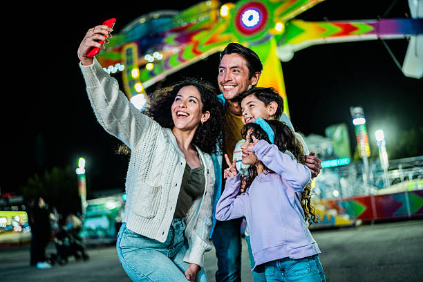 istock Family taking a selfie at amusement park 2210266125