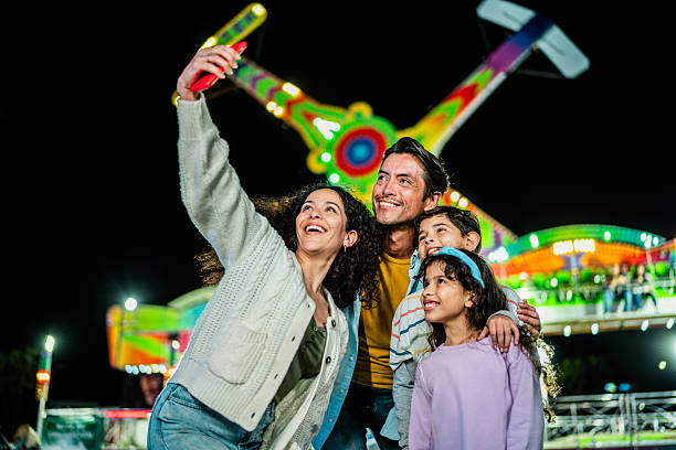 istock Family taking a selfie at amusement park 2210266135