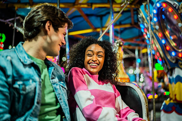 istock Happy young couple carousel at amusement park 2210266286