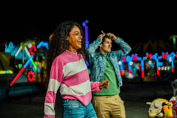 istock Young couple playing at amusement park 2210266294