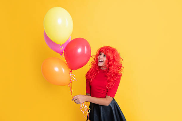 istock positive child with party balloon on yellow background 2210267018
