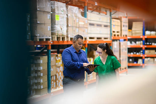 istock Manager and employee collaborating with a tablet in a medical warehouse 2210267097