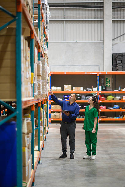 istock Warehouse manager and medical staff inspecting inventory with a tablet 2210267128