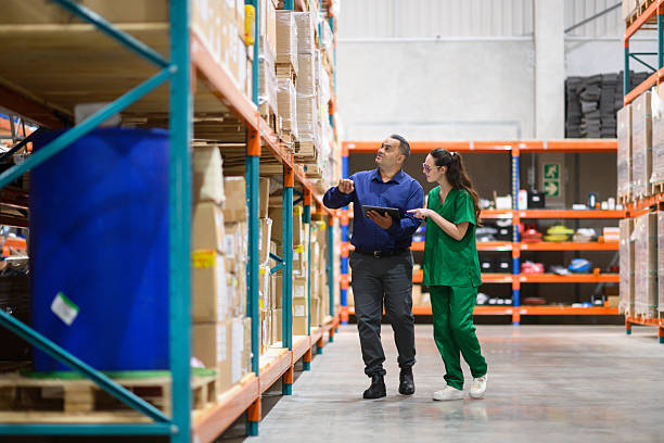 istock Manager and medical worker reviewing inventory in a warehouse 2210267135