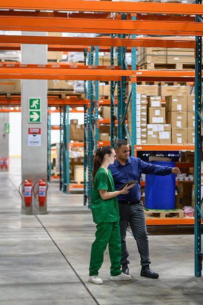 istock Manager and staff collaborating in a medical warehouse stock check 2210267150