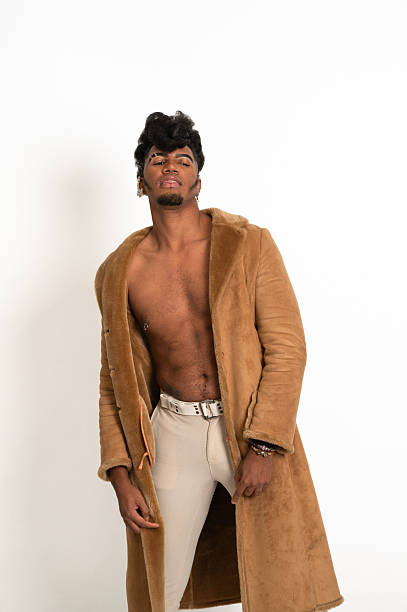 istock Fashion model posing with open brown coat and beige pants 2210267162