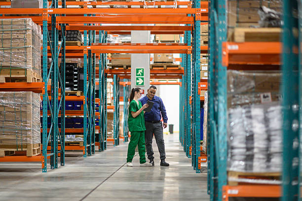 istock Manager and employee reviewing inventory in a medical warehouse setting 2210267169