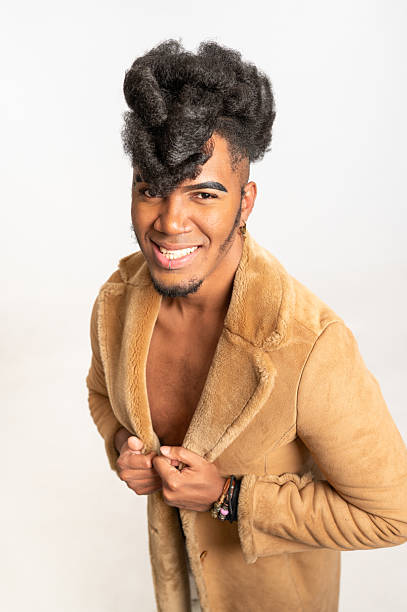 Young stylish black man smiling and wearing a fur coat