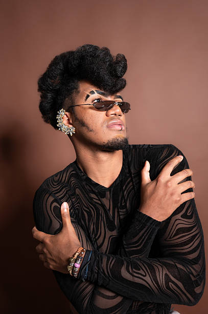 istock Young man with makeup and jewelry posing in studio 2210268590