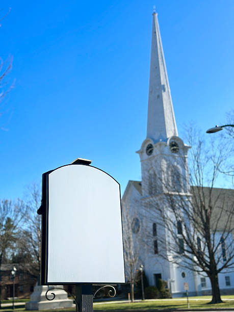 Blank sign in front of a Colonial style church with clock tower