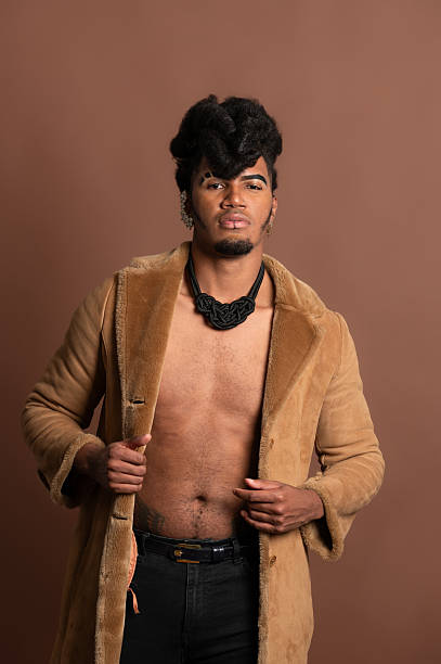 istock Fashion model posing with open brown coat and showing abs 2210269366