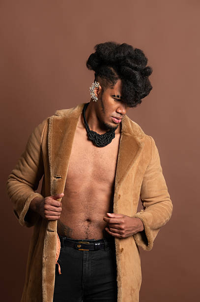 istock Stylish man opening fur coat and showing abs 2210269427