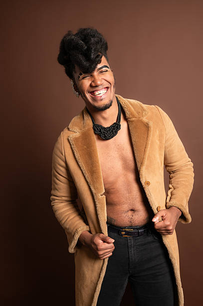 istock Stylish young man smiling and opening his fur coat 2210269642