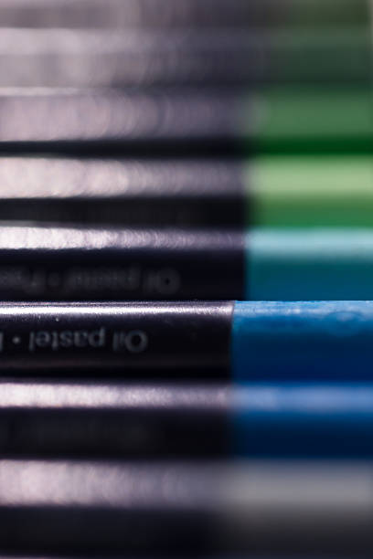 Close-up of a colorful collection of oil pastel crayons with a blurred artistic background. Perfect representation of focus and creative workspace mood.