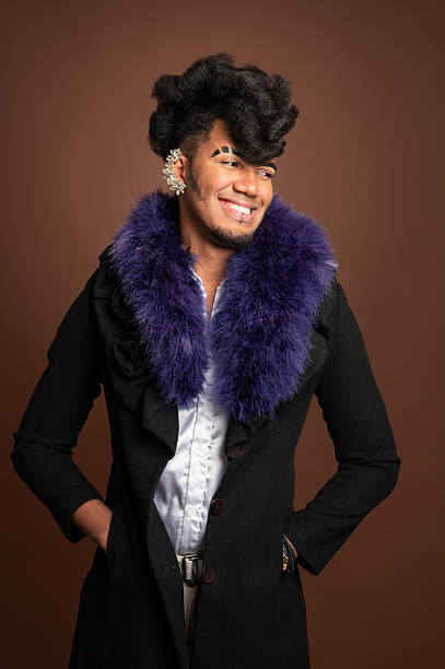 istock Stylish young man smiling and looking away with hands in pockets 2210270050