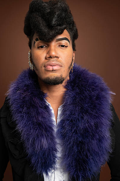 istock Stylish young man posing with feather boa and unique hairstyle 2210270174