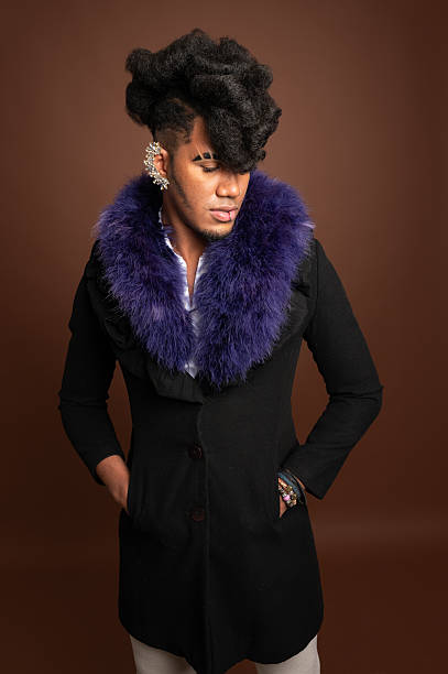 istock Stylish young man posing with hands in pockets and fur collar 2210270195