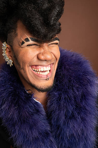 istock Stylish man wearing a fur coat is laughing with eyes closed 2210270270