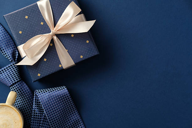 istock Father's Day gift box with tie and coffee on blue background. Perfect for masculine gift concepts. 2210270780