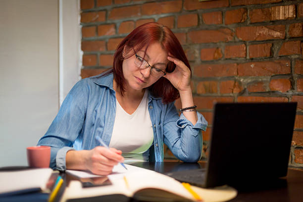 istock Immersed in study and planning at the home desk 2210272266