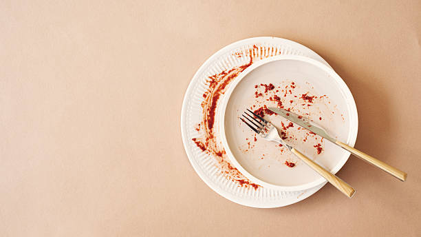 istock Empty plate with crumbs after eating on a orange background 2210274759