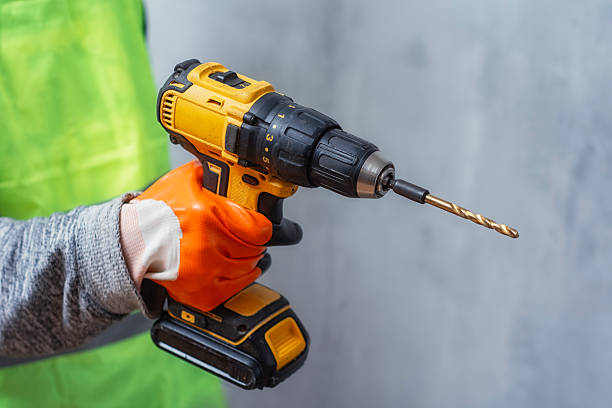 istock A construction worker in a bright safety vest holds a cordless drill. Powerful tool for construction and DIY projects. 2210276608