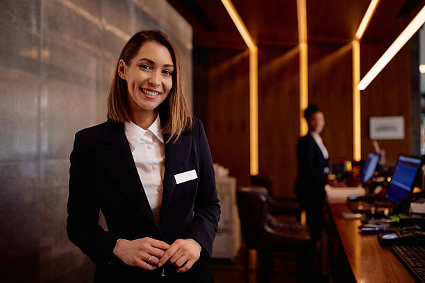 istock Happy female receptionist working in a hotel and looking at camera. 2210276702