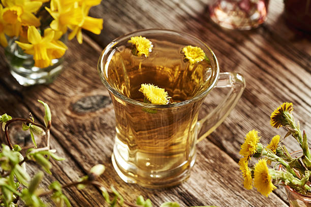 istock Coltsfoot flower tea in a glass cup 2210277217