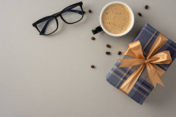 istock A cozy scene featuring a cup of coffee next to eyeglasses and a wrapped gift box 2210278819