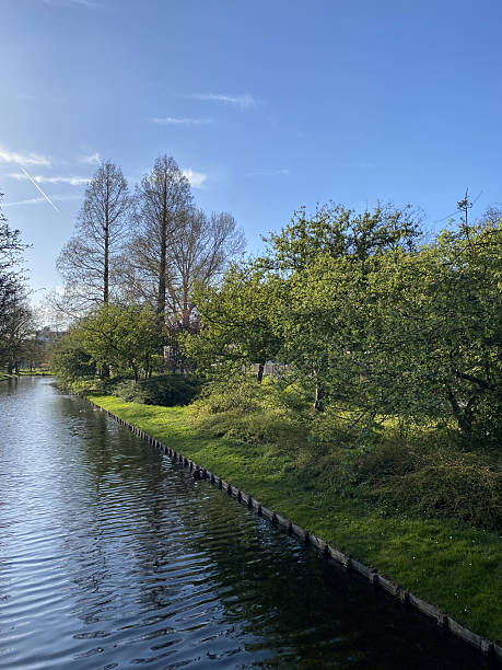 istock Green Canal with Trees and Reflections 2210279358