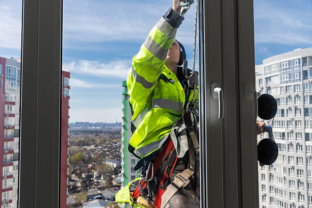istock A Professional Window Cleaner in High-Rise Building Using Safety Gear While Focusing on Cleaning Glass Windows to Ensure Clarity and Visibility, Showcasing Urban Life and Architecture 2210289710