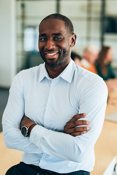 istock Smiling Businessman in a Professional Meeting Environment 2210289820