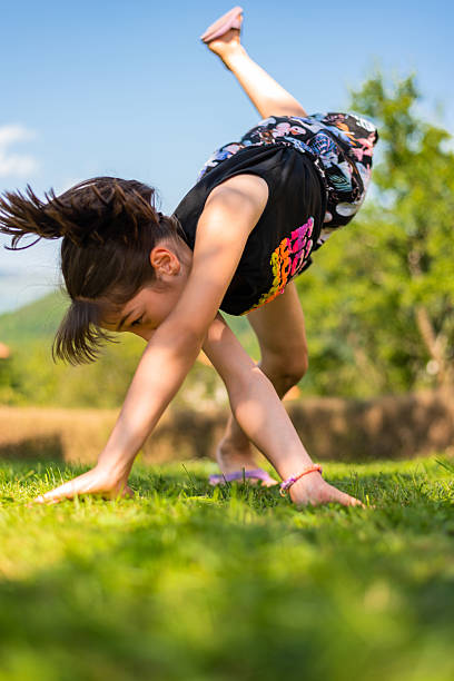 A happy child girl climbing up on the rope in the park playground. High quality photo