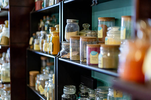 istock Various spices and herbs stored in glass jars on shelves 2210290530
