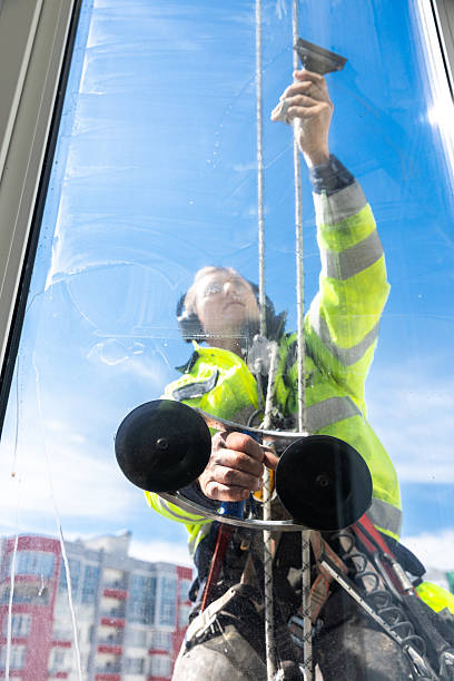 istock Dedicated Window Cleaner Scaling Heights to Ensure Crystal Clear Views in Abodes with Bright Blue Skies in the Background 2210291051