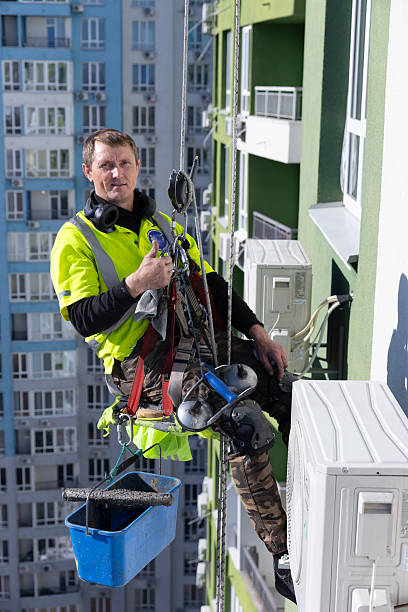 istock A Hardworking Window Cleaner Dangles from a High-Rise Building While Carrying Equipment and Giving a Thumbs Up to the Camera Amidst the Urban Landscape 2210291657