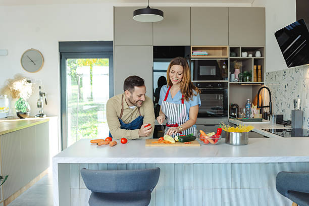 istock Couple preparing fresh vegetables together in a modern kitchen environment 2210293960