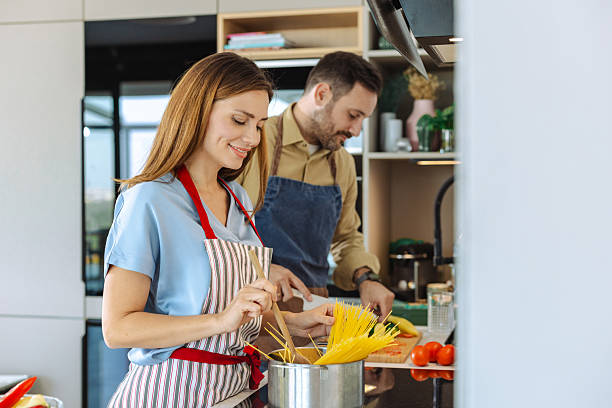 istock Couple preparing pasta together in a modern domestic kitchen setting 2210294129