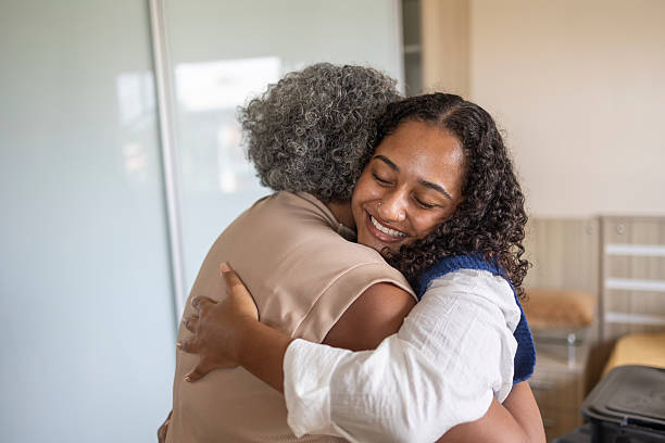 istock Young Latina hugging her middle-aged mother in the university dormitory 2210294568