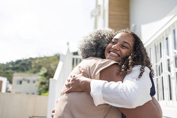 istock Young Latina hugging her middle-aged mother outside a university dormitory 2210294570