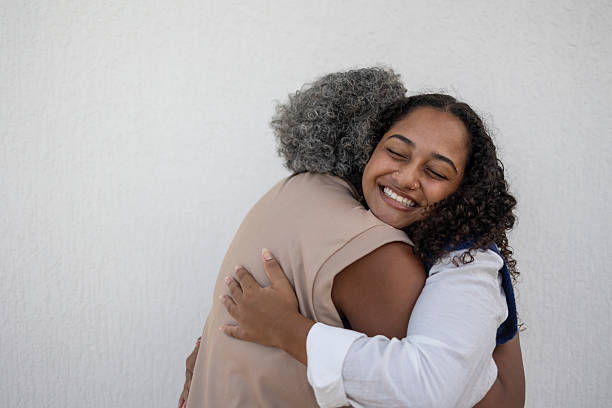 istock Young Latina hugging her middle-aged mother outside a university dormitory 2210294571