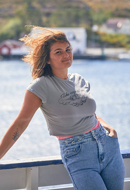 istock Casual Woman Posing Outdoors by Water on a Sunny Day 2210295857